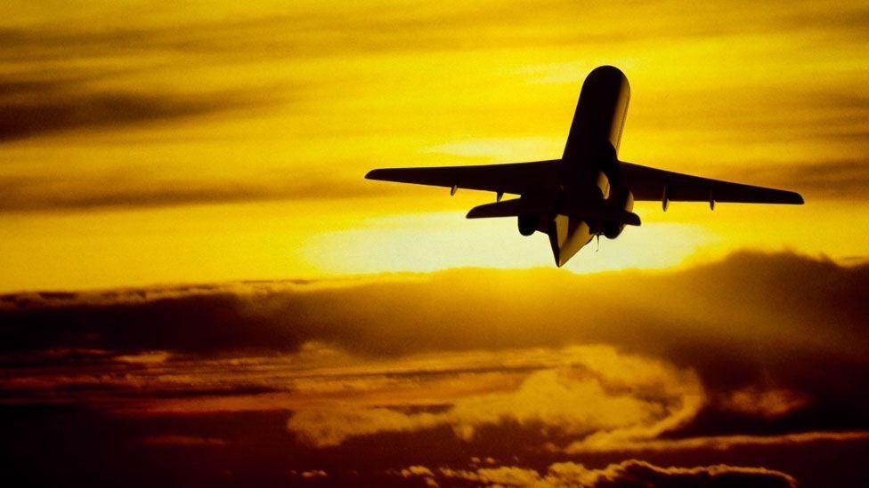 Aeroplane taking off at sunset for people arriving in Australia